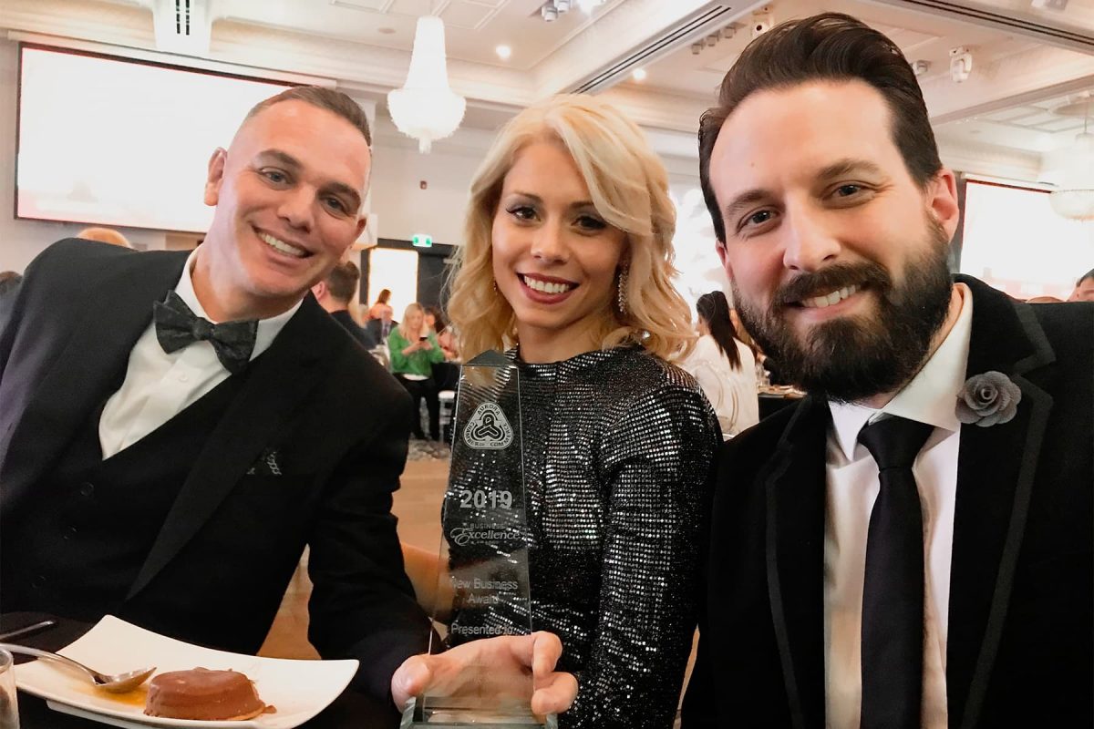 Eric, Monica, and Ryan accepting the 2019 Business Excellence Award